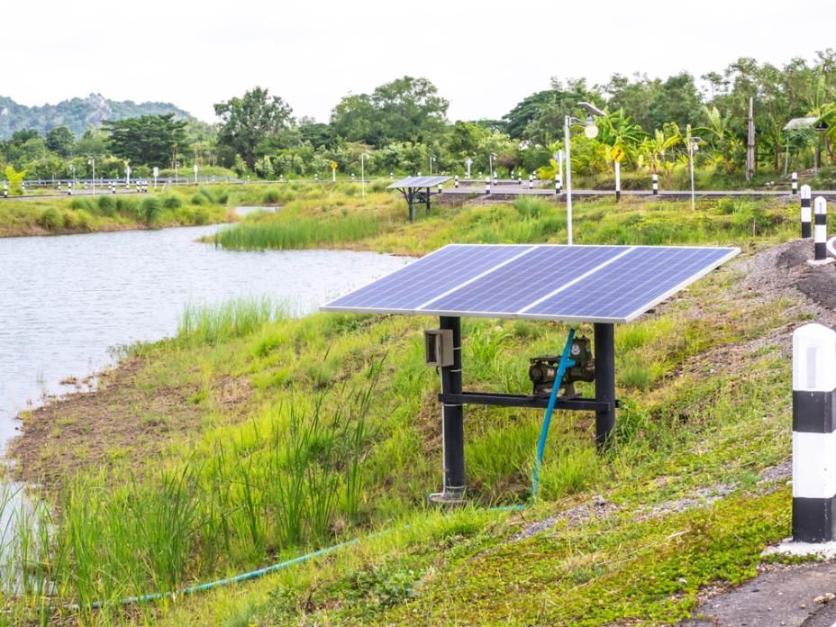 A Solar Panel Is Sitting Next To A Body Of Water — Mission Solar And Electrical In Mission Beach, QLD