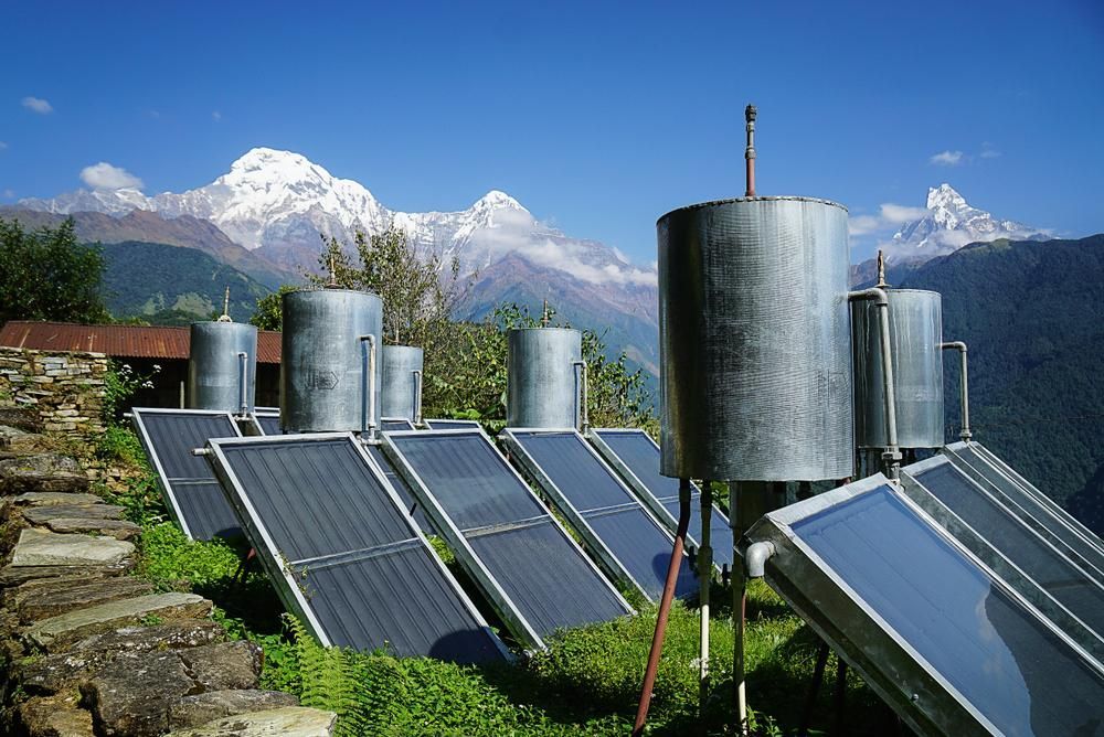 A Row Of Solar Panels With Mountains In The Background — Mission Solar And Electrical In Cardwell, QLD