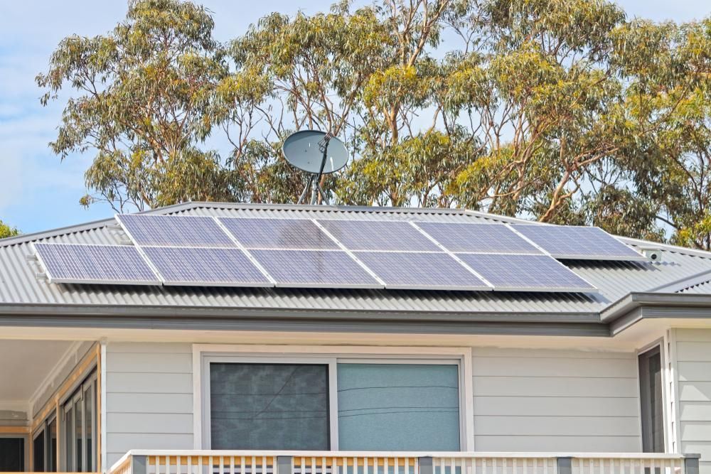 A House With Solar Panels On The Roof And A Satellite Dish — Mission Solar And Electrical In Mission Beach, QLD