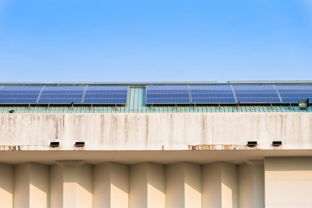 A Row Of Solar Panels On The Roof Of A Building — Mission Solar And Electrical In Tully, QLD