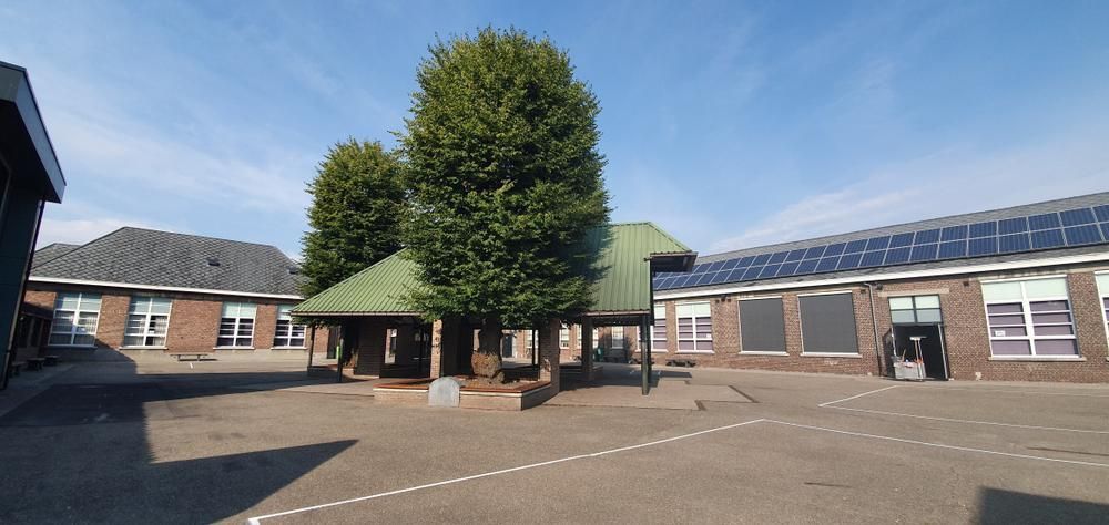 A Brick Building With A Green Roof And Solar Panels On The Roof — Mission Solar And Electrical In Cardwell, QLD