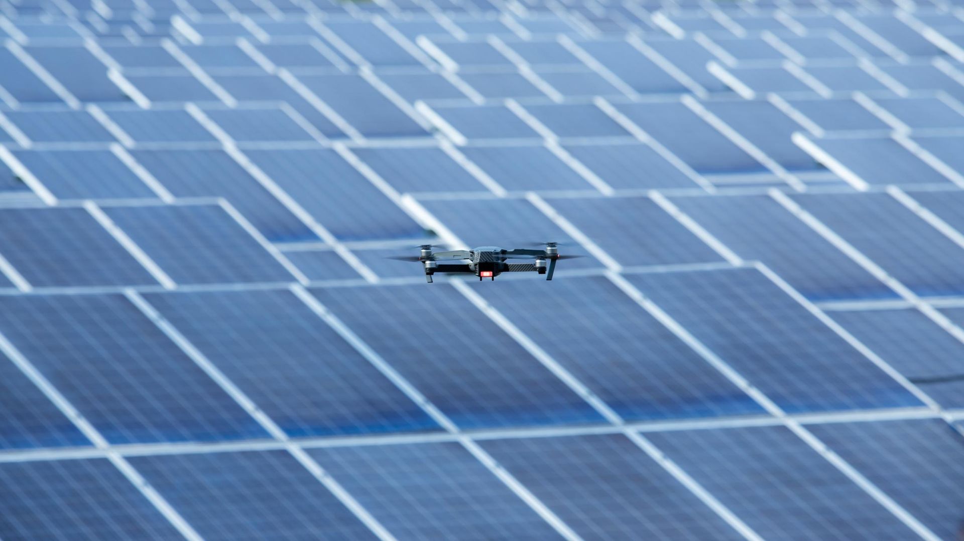 A Drone Is Flying Over A Solar Panel Field — Mission Solar And Electrical In Innisfail, QLD