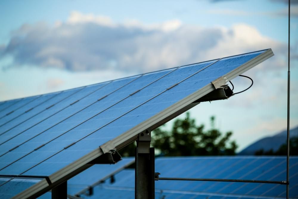 A Close Up Of A Solar Panel With A Cloudy Sky In The Background — Mission Solar And Electrical In Mission Beach, QLD