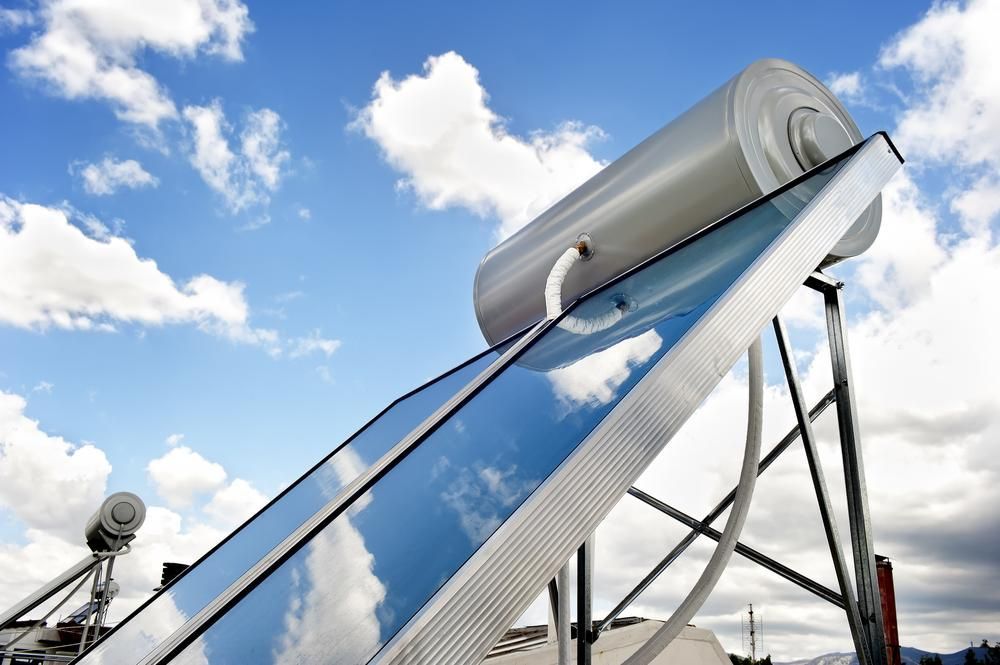 A Solar Water Heater With A Blue Sky In The Background — Mission Solar And Electrical In Tully, QLD