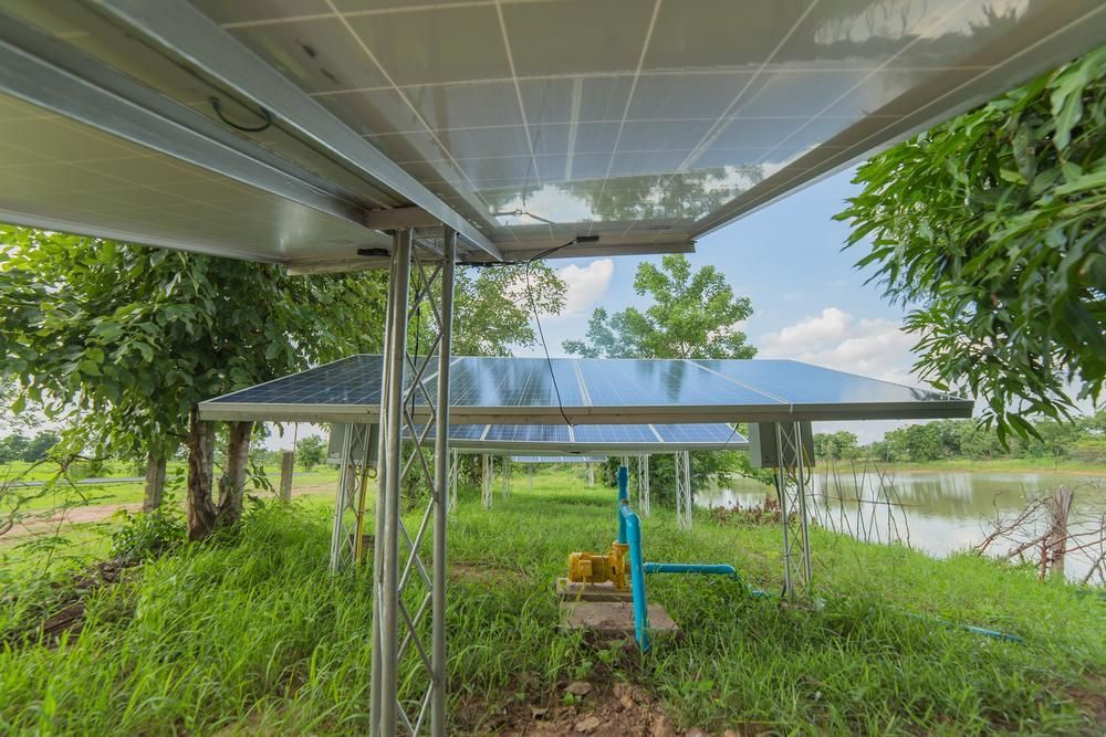 A Solar Panel Is Sitting On Top Of A Metal Structure In A Field — Mission Solar And Electrical In Mission Beach, QLD