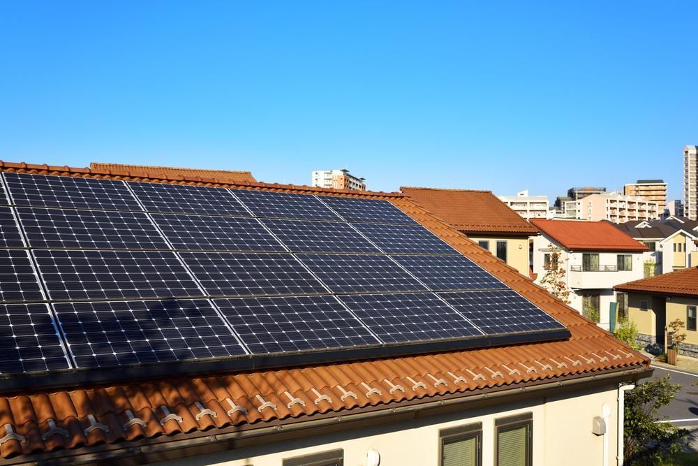 There Are Many Solar Panels On The Roof Of A House — Mission Solar And Electrical In Mission Beach, QLD
