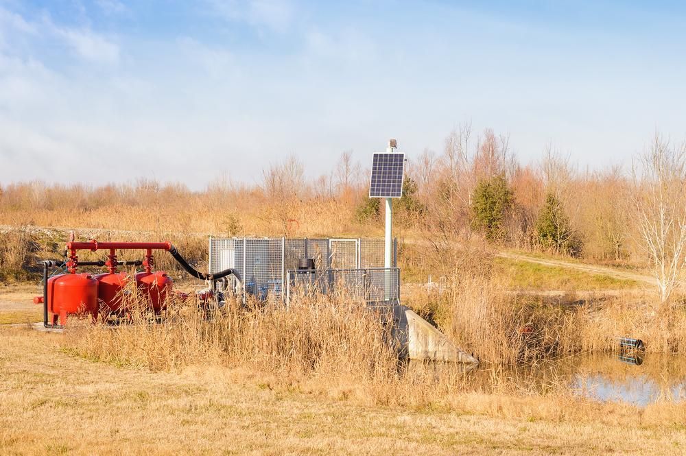 A Solar Panel Is Sitting In The Middle Of A Field — Mission Solar And Electrical In Cardwell, QLD