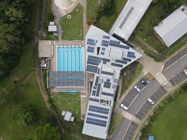 Aerial View Of A Swimming Pool With Solar Panels — Mission Solar And Electrical In Mission Beach, QLD