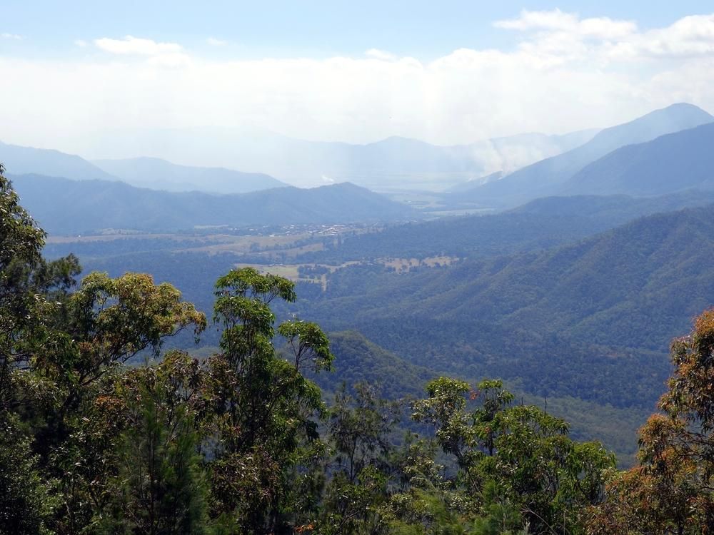 A View Of A Mountain Range With Trees In The Foreground — Mission Solar And Electrical In Innisfail, QLD