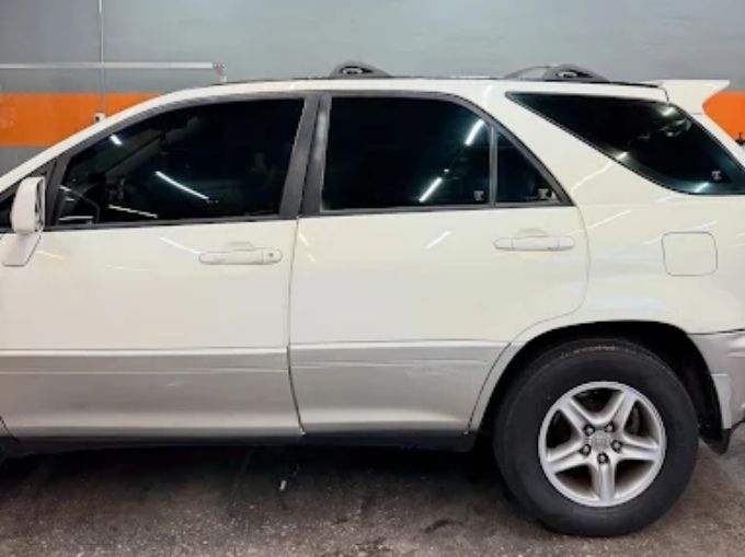 White Lexus RX SUV in a garage with freshly applied window tint on all side windows