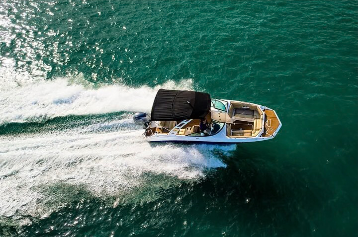 Aerial view of a private boat cruising across Biscayne Bay in Miami