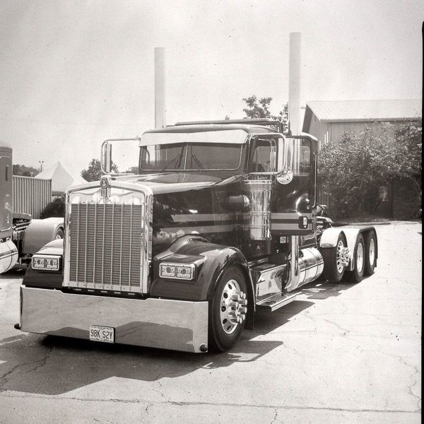 A black and white photo of a kenworth semi truck