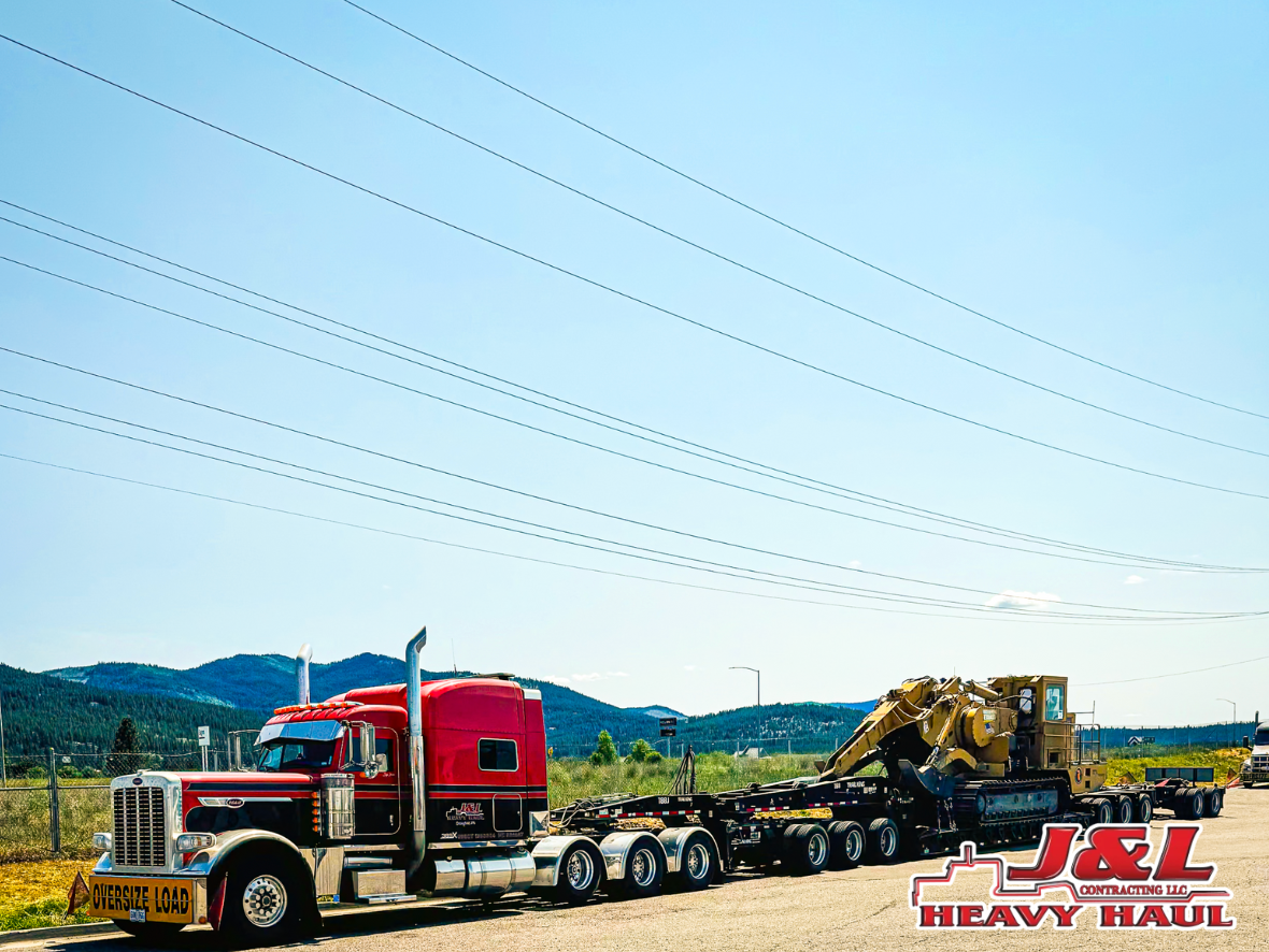 A red semi truck is parked on the side of the road.