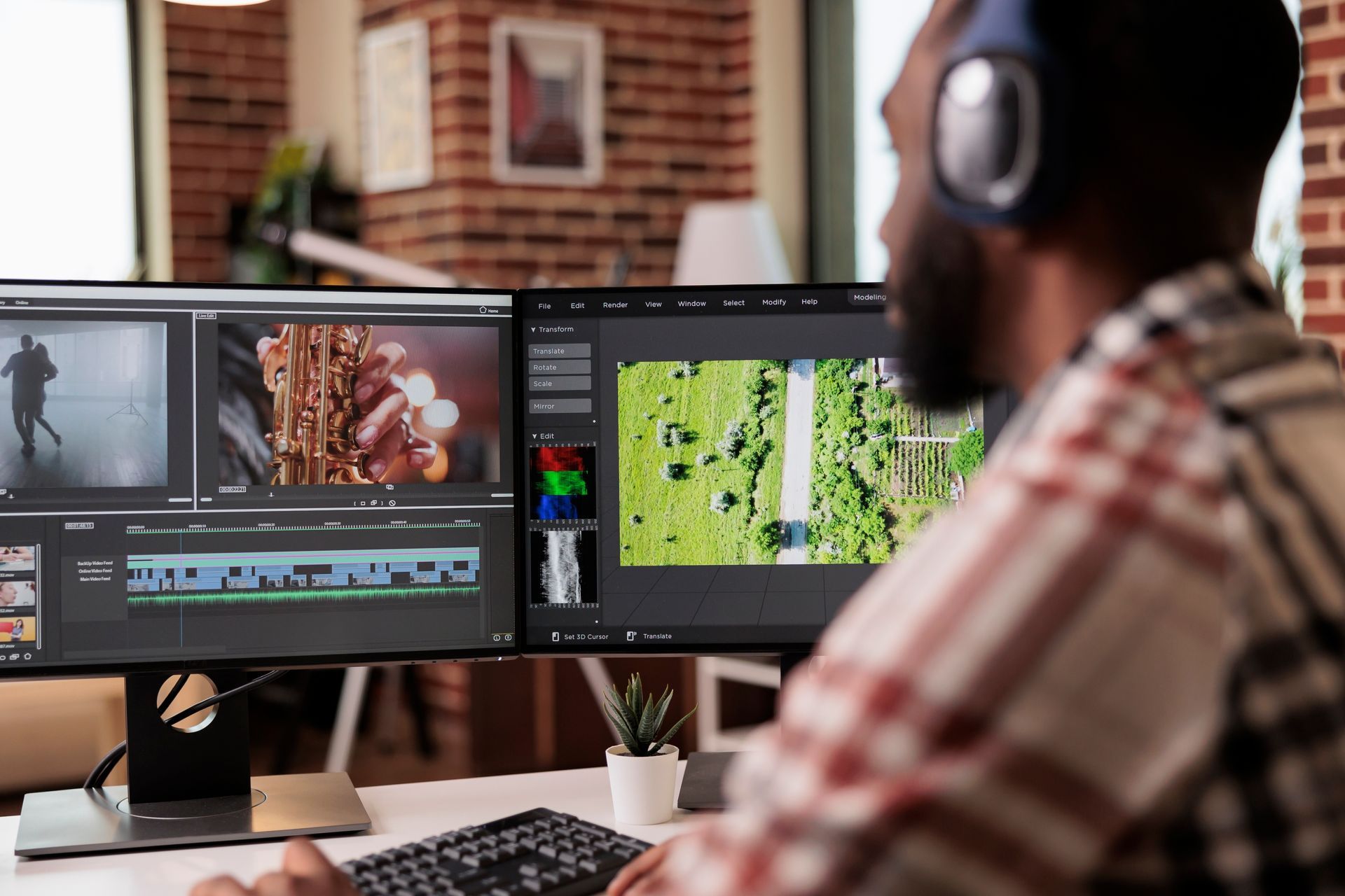 A man wearing headphones is editing a video on a computer.