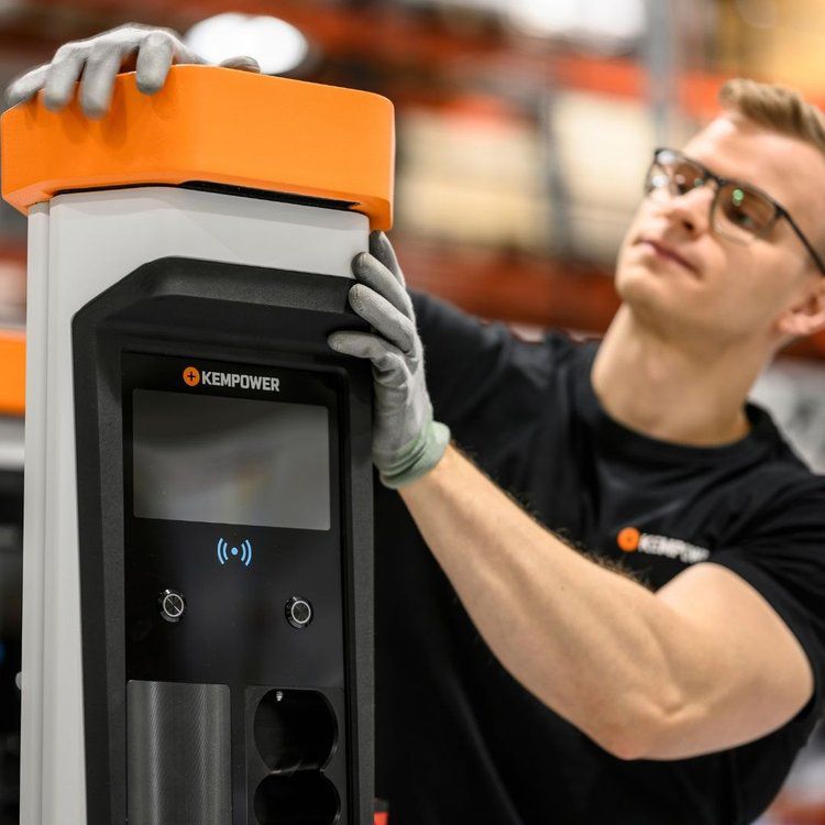 A man wearing gloves is working on a kepower machine