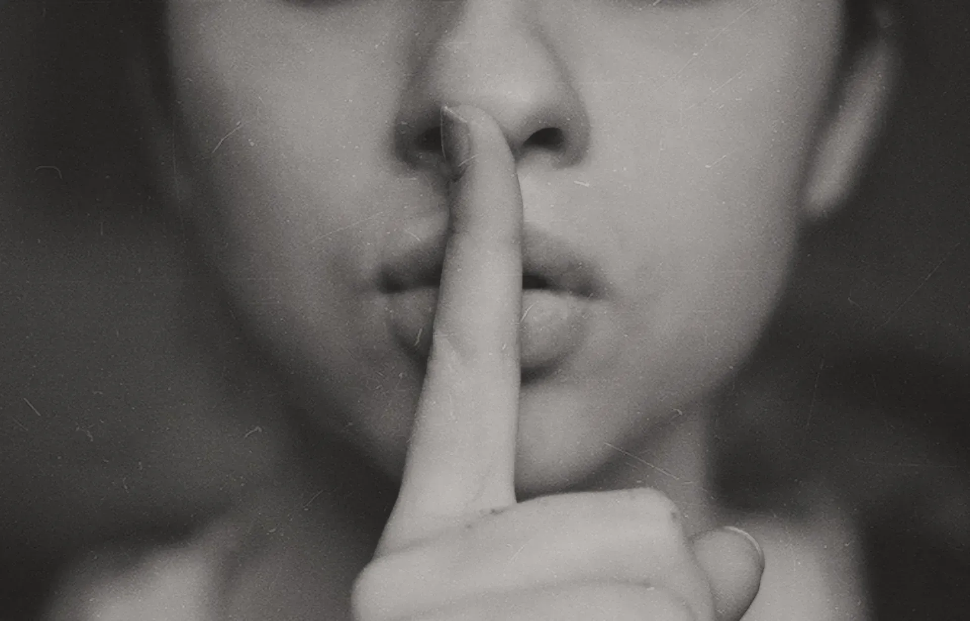 woman in silent hand gesture