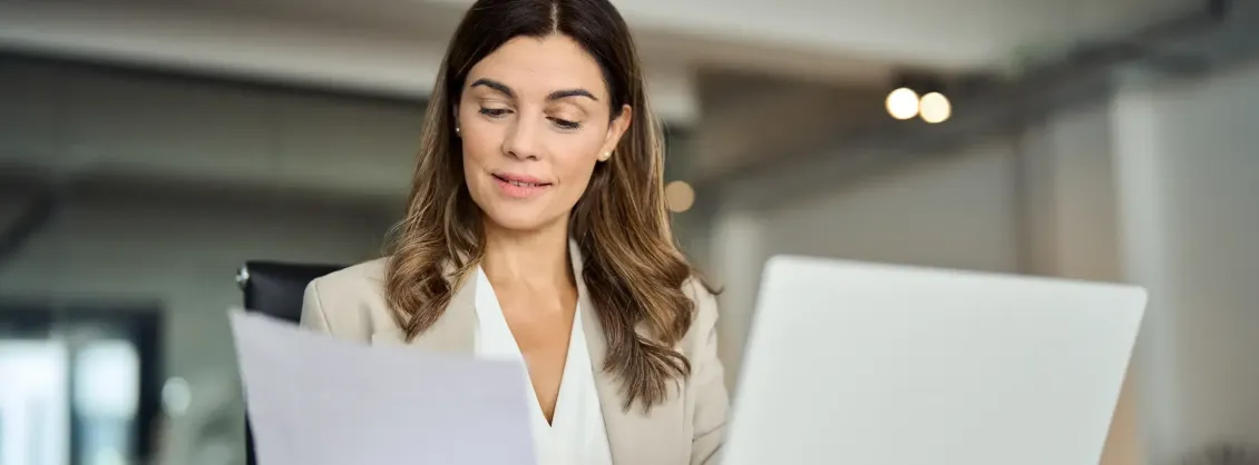 A woman reading a sheet of paper
