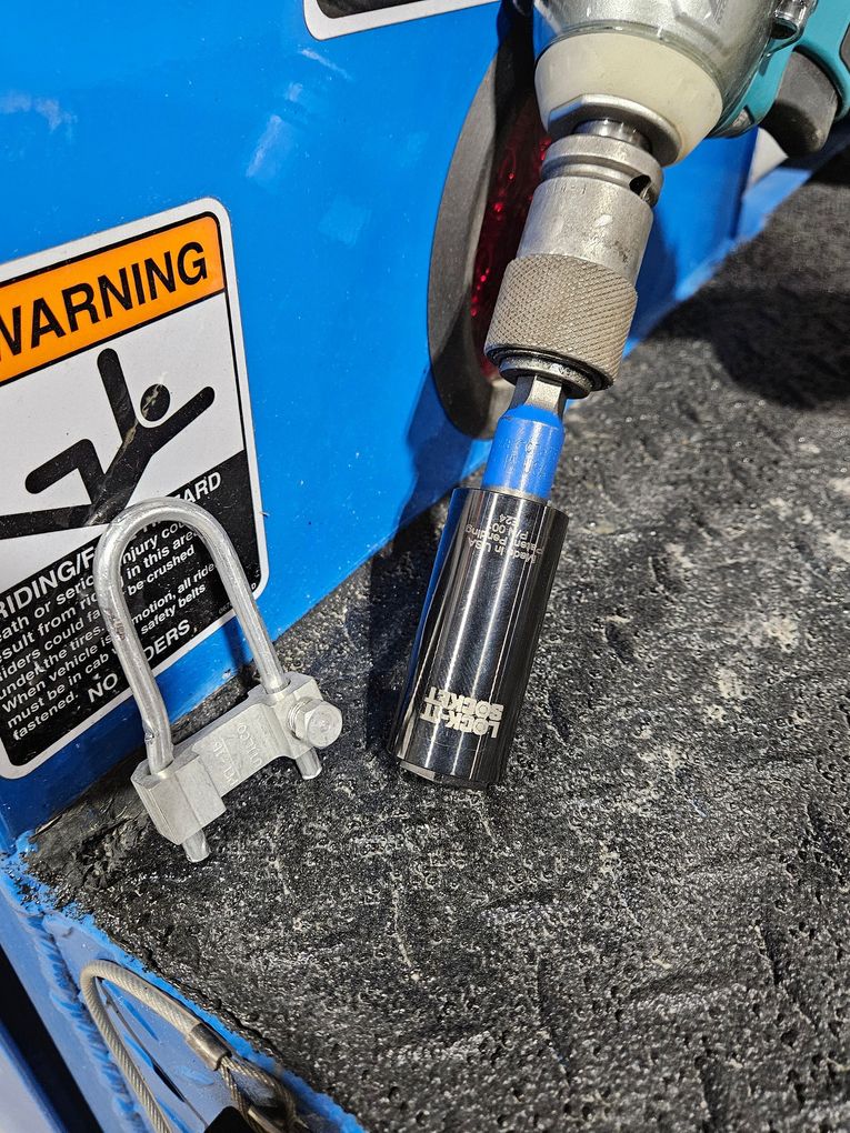 The Lock-It Socket attached to a drill with a one-time bolt
