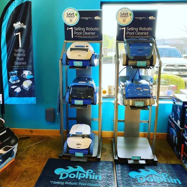 Pool cleaner displays in a store with multiple Dolphin robotic pool cleaners.
