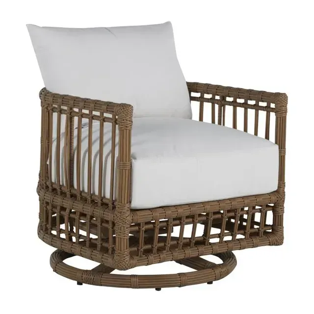 Brown wicker swivel chair with white cushions.