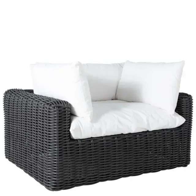Dark gray wicker outdoor lounge chair with white cushions.