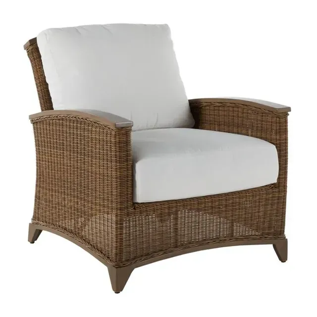 Wicker outdoor armchair with white cushions.
