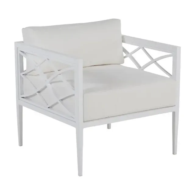 White outdoor armchair with geometric lattice design on the sides and white cushions.