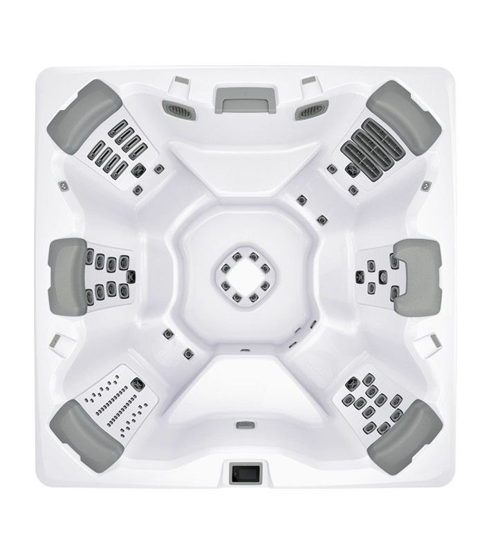Overhead view of a white hot tub with grey headrests and various jet configurations.
