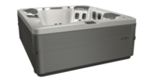A gray and white square hot tub with multiple jets, indoors.