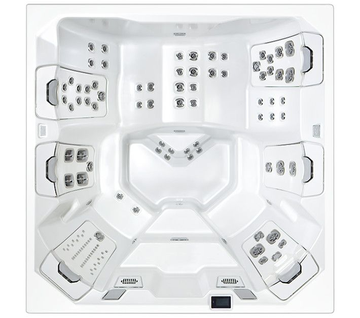 Overhead view of a white square hot tub with various jet arrangements and multiple seating areas.