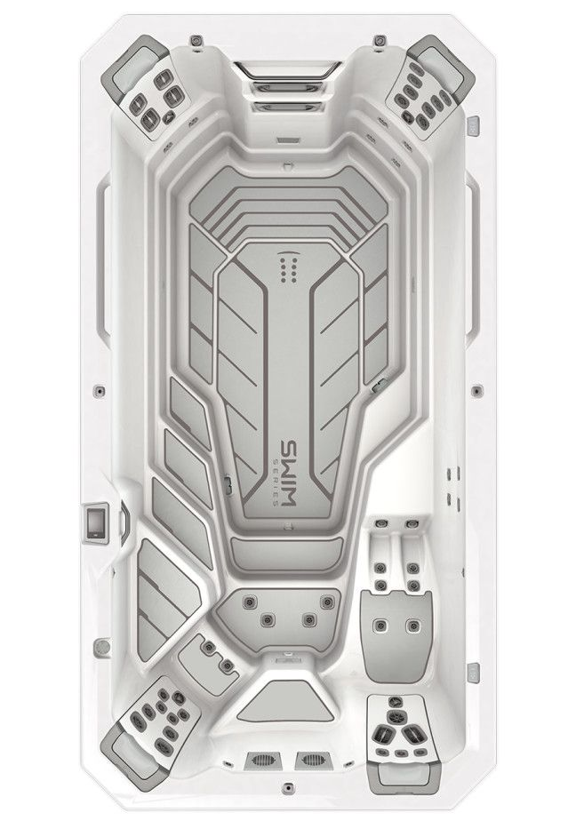 Top-down view of a white and gray swim spa with built-in jets and control panels.