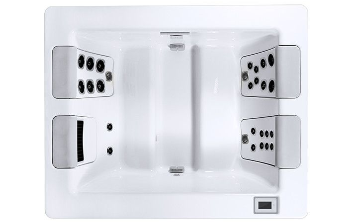 Top-down view of a white rectangular hot tub with multiple jets, seats and a control panel.