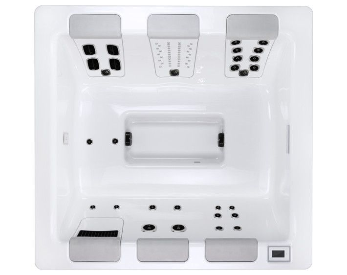 Overhead view of a white hot tub with multiple jet seating areas and control panel.