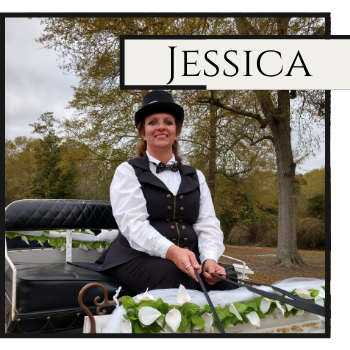 Jessica smiling in a black hat and vest on a decorated carriage outdoors in autumn