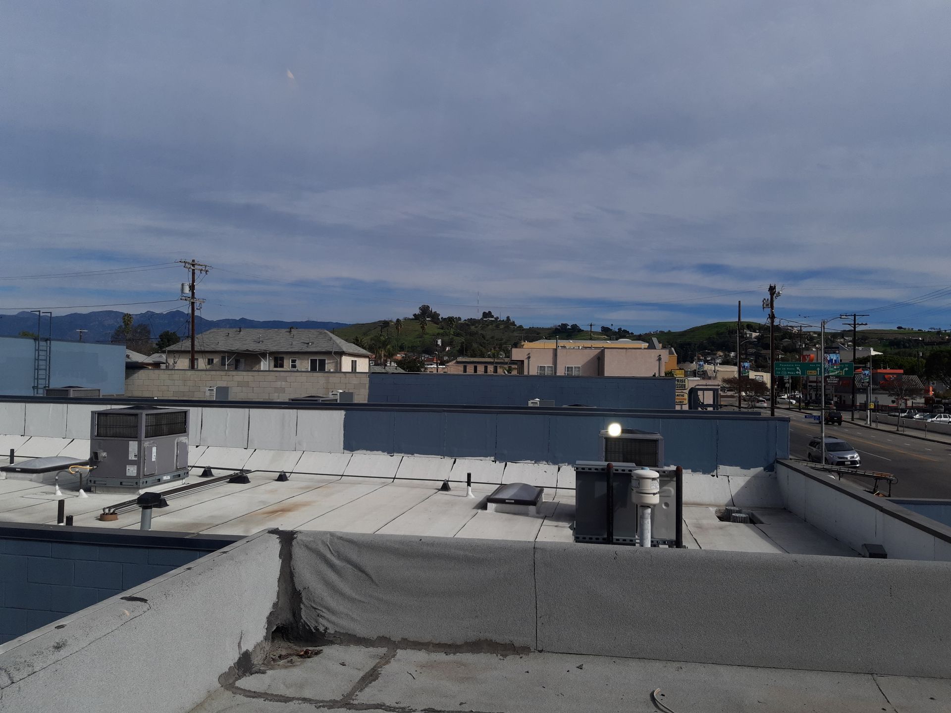 A rooftop view of a city with mountains in the background