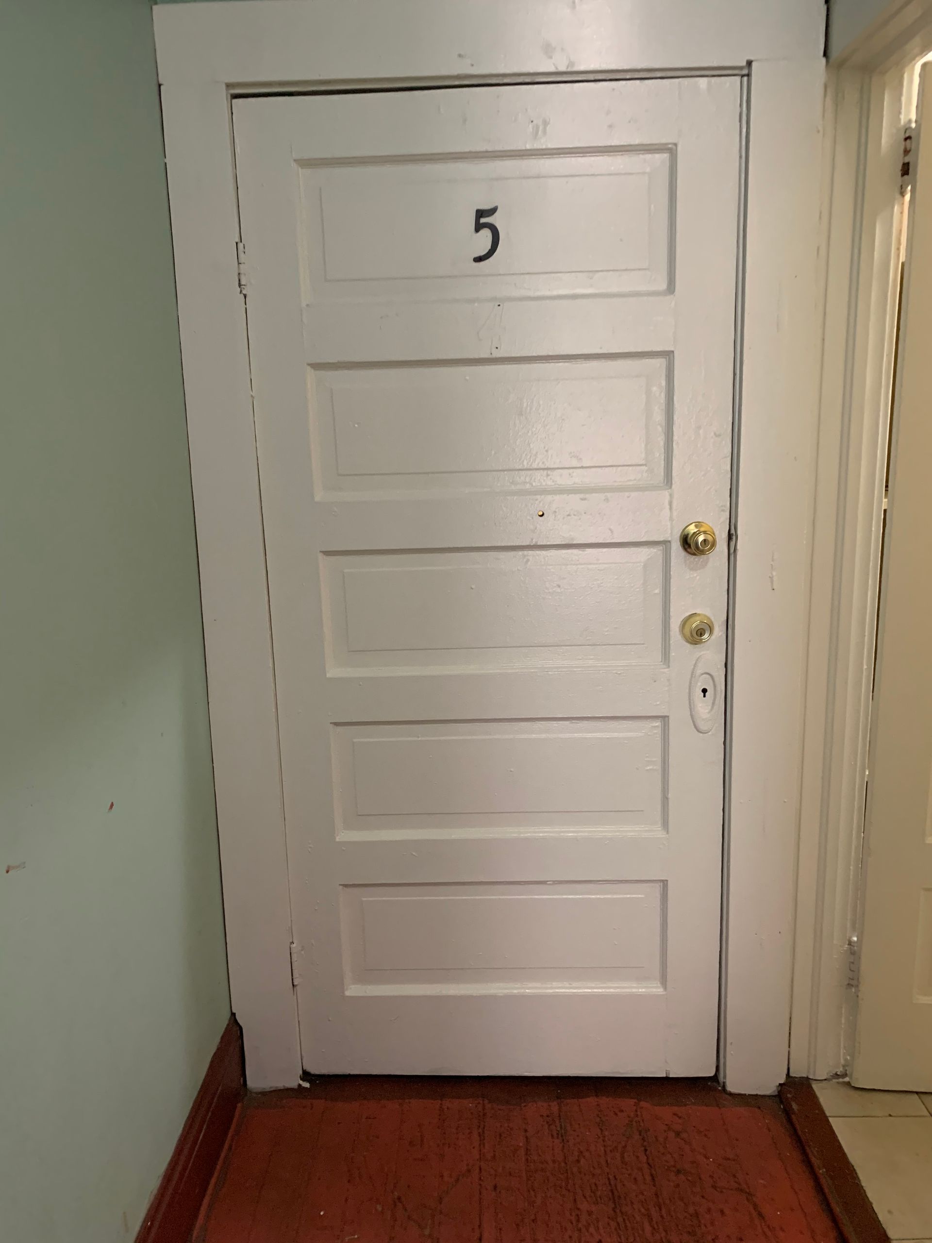 A white door with the number 5 on it