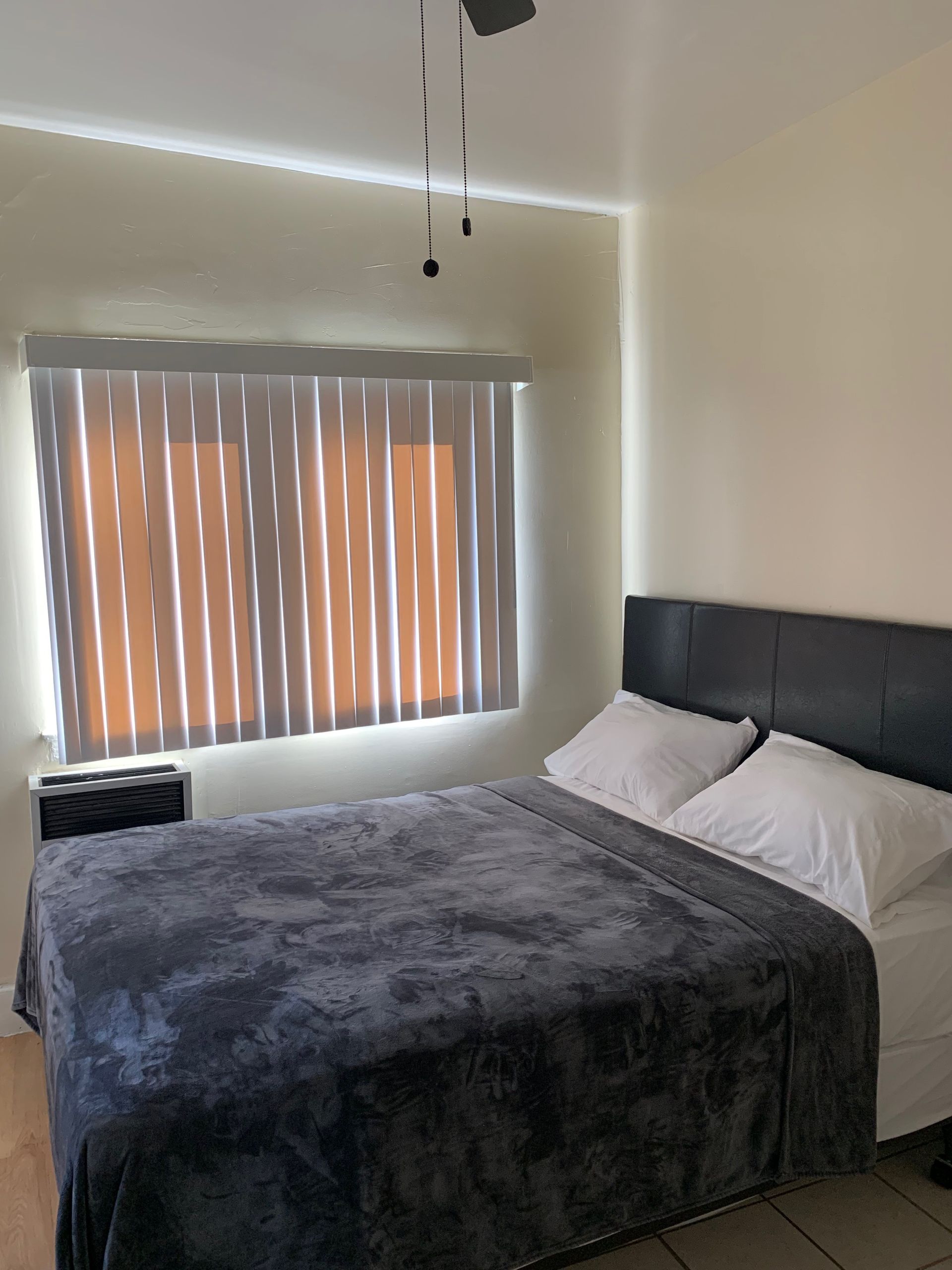 A bedroom with a large bed and a window