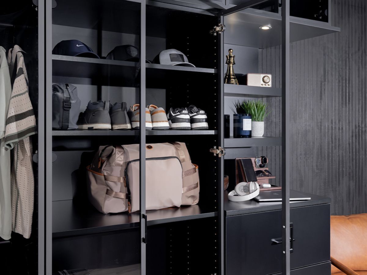 Open walk-in closet with shelves of shoes, bags, and accessories in a modern dark interior