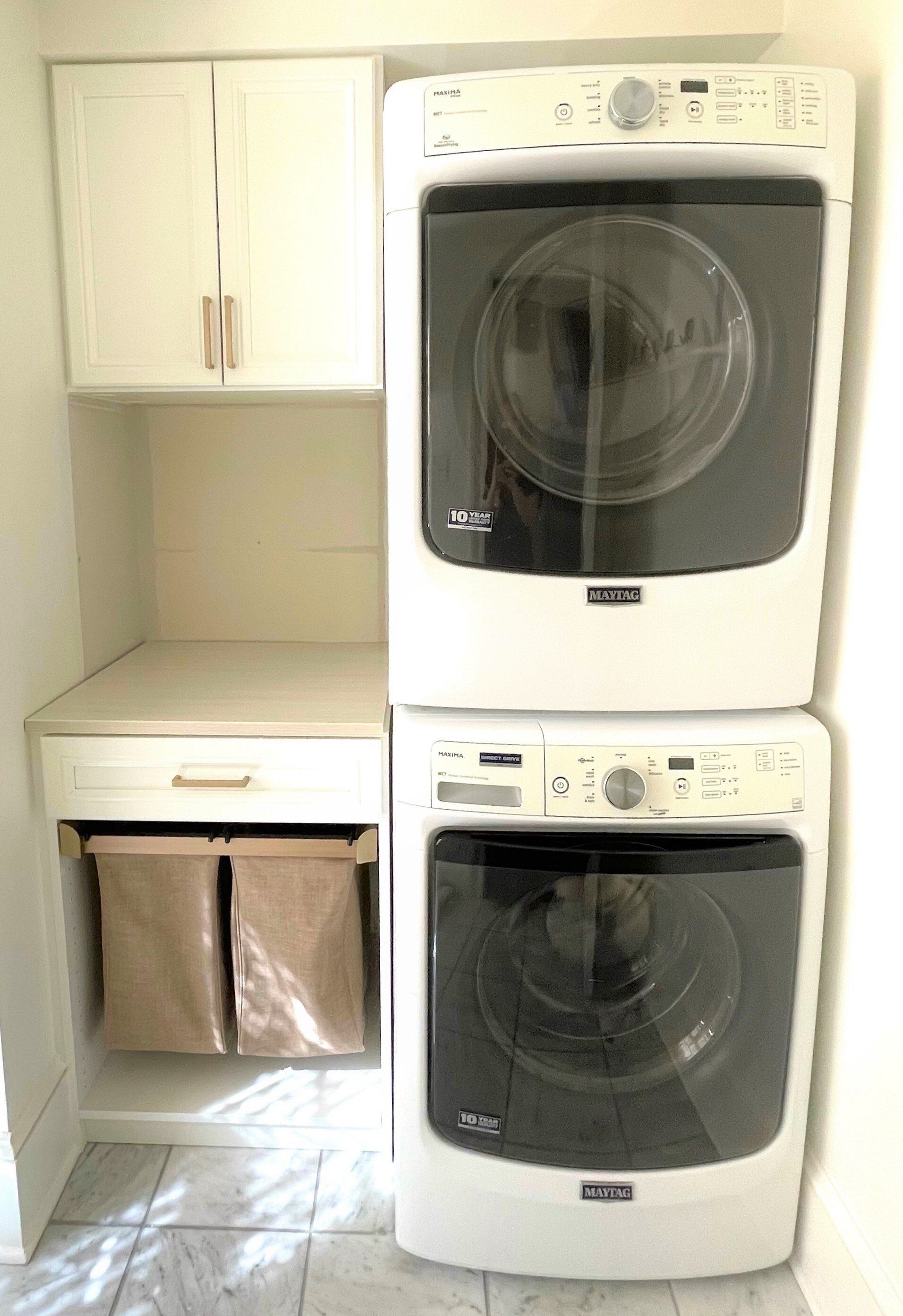 A washer and dryer are stacked on top of each other in a laundry room.