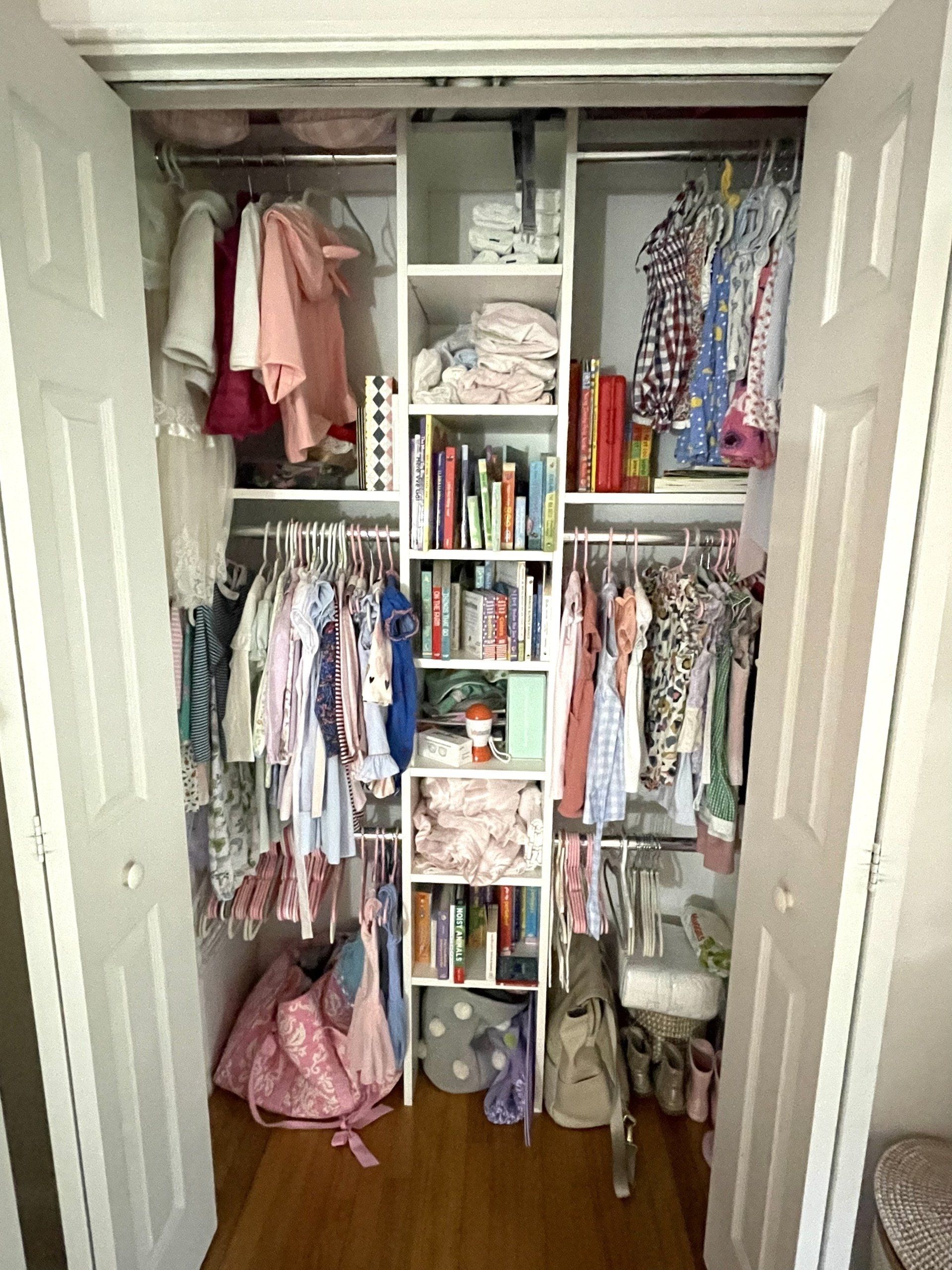 A closet filled with lots of clothes and books.