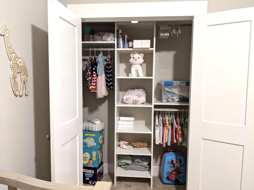 A closet filled with clothes and a stuffed animal.
