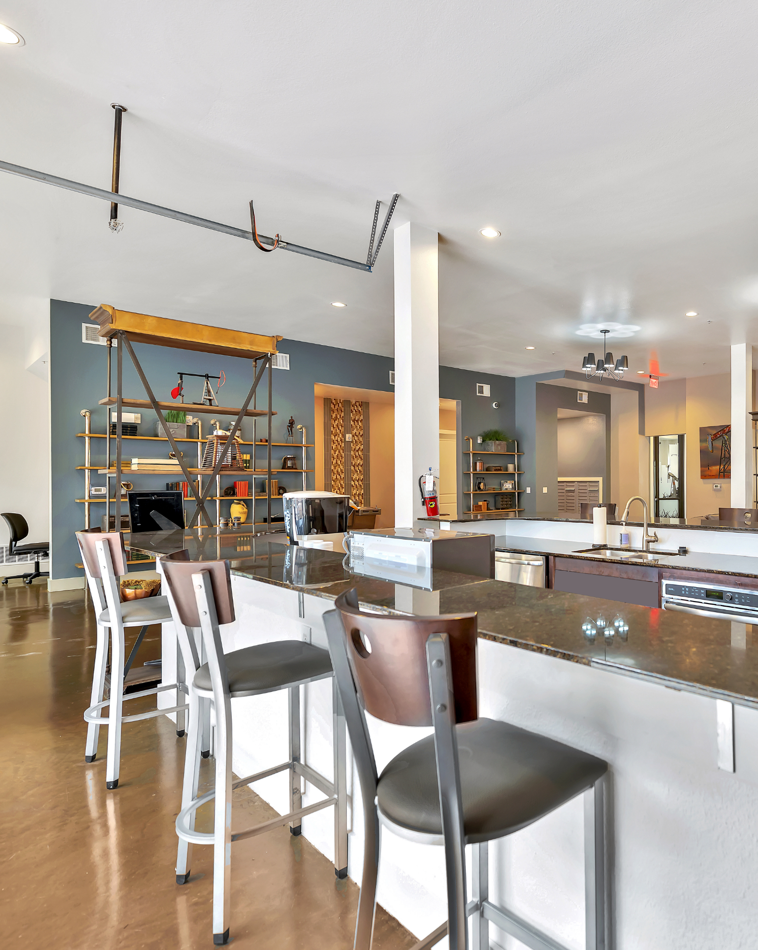 A kitchen with a bar and stools in it.