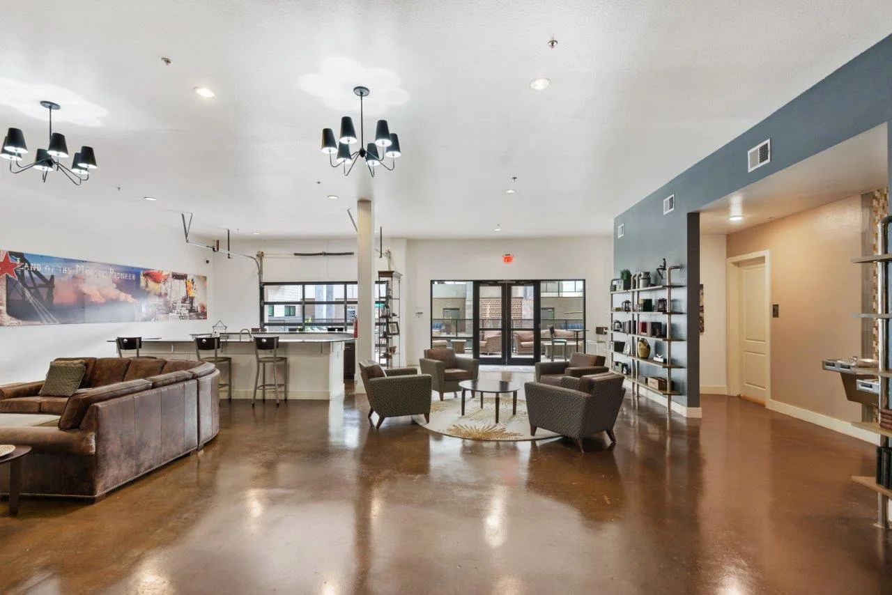 A large living room filled with furniture and a kitchen.