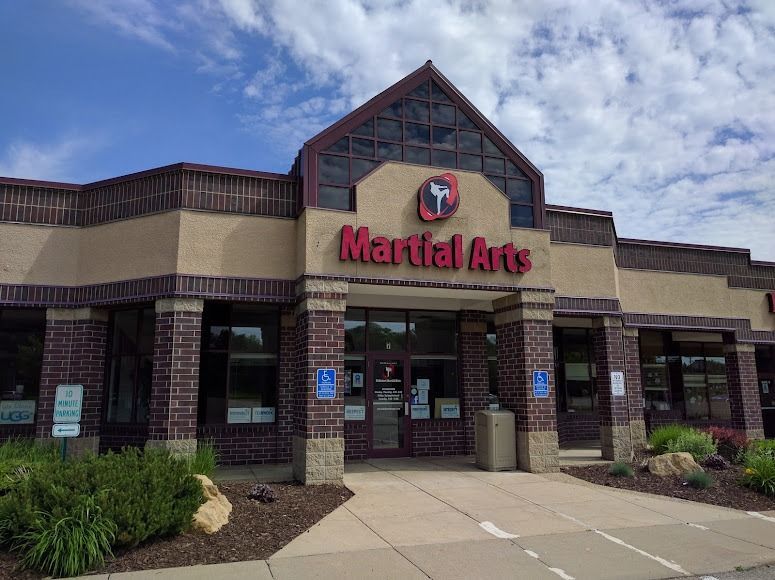 A brick and beige commercial building with a sign that reads 