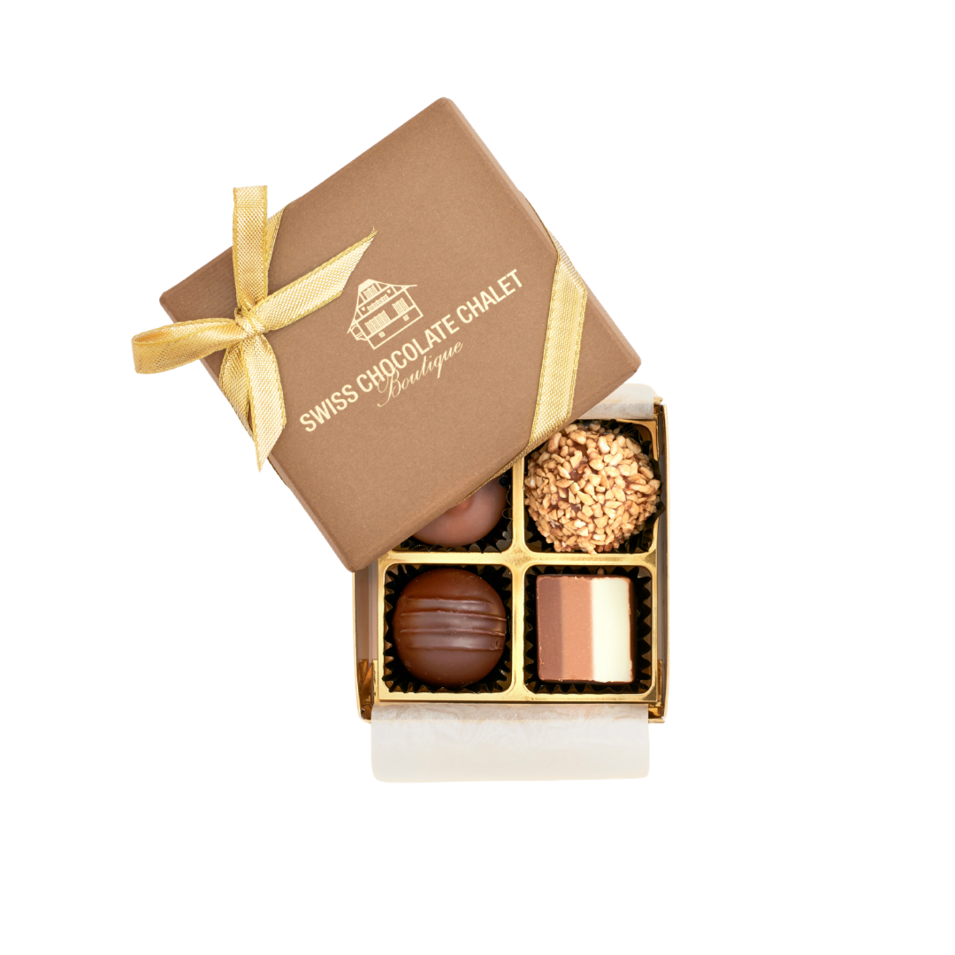 Offene Pralinenschachtel mit einer goldenen Schleife auf einem braunen Deckel