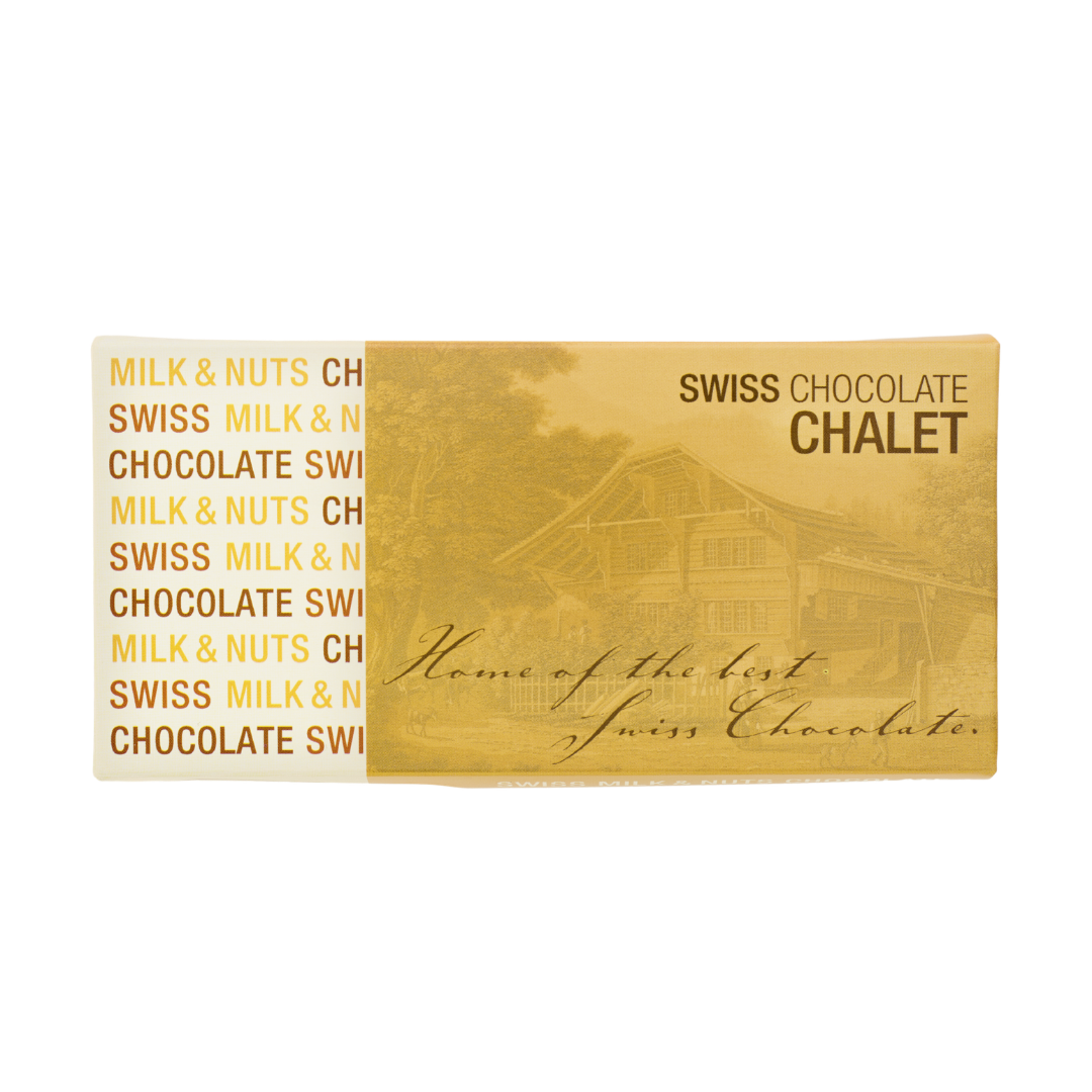 Goldene Schweizer Schokoladen-Chalet-Box mit dem Schriftzug „Milk & Nuts“ auf der linken Seite