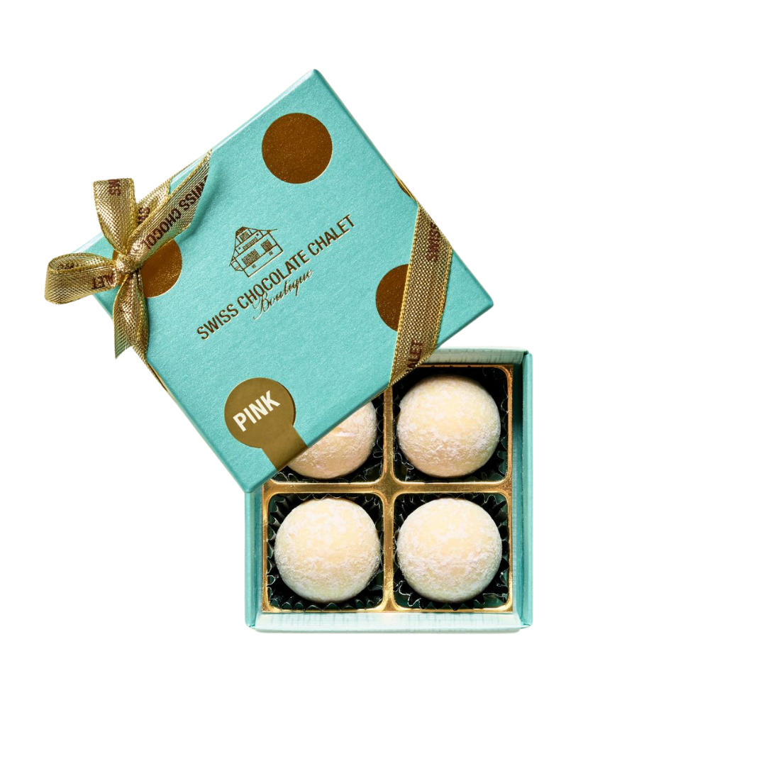 Türkisfarbene Geschenkbox mit goldenen Punkten und Schleife, die sich öffnet und neun runde Truffes im Inneren enthüllt
