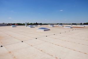 There are many skylights on the roof of a building.