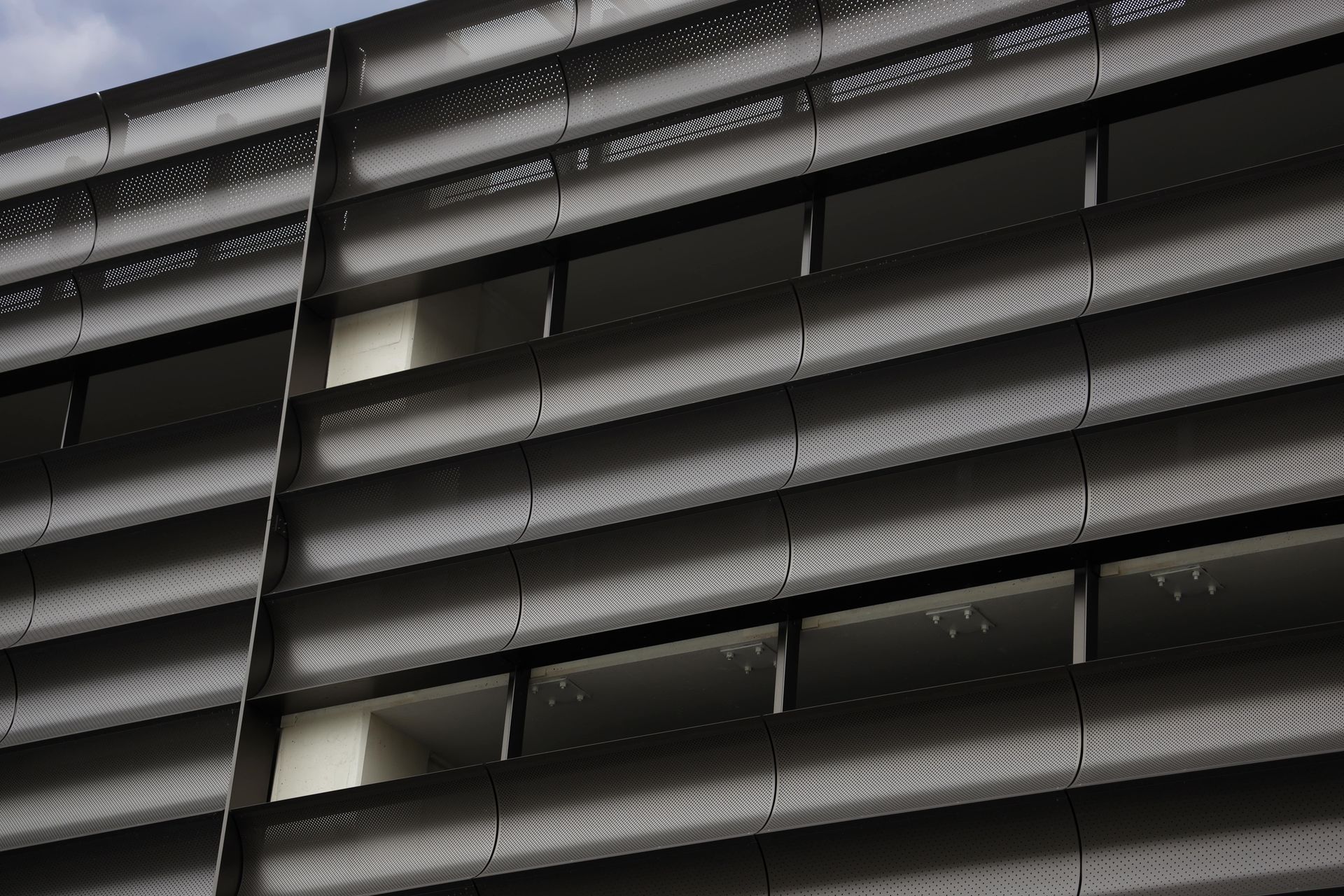 A black and white photo of a building with a lot of windows