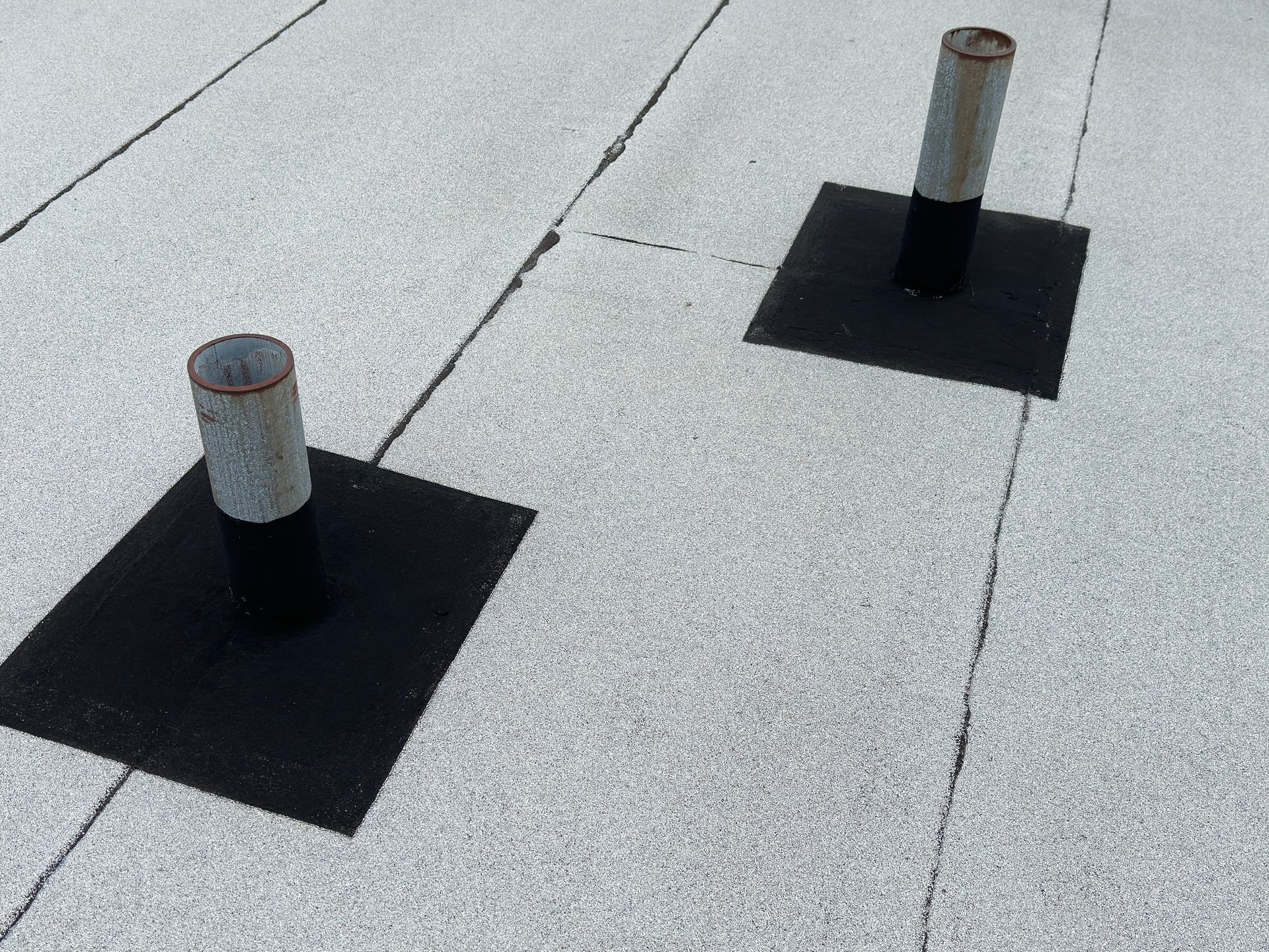 Flat roof surface with sewer vents, highlighting flat roof repair.